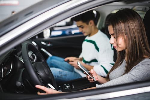 Driver and Copilot both on their cellphones while driving